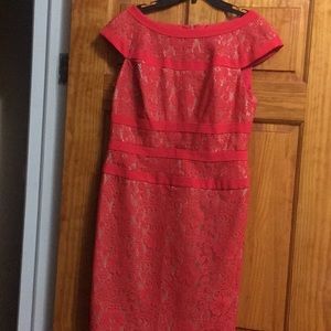 A deep coral lace with nude lining cocktail dress